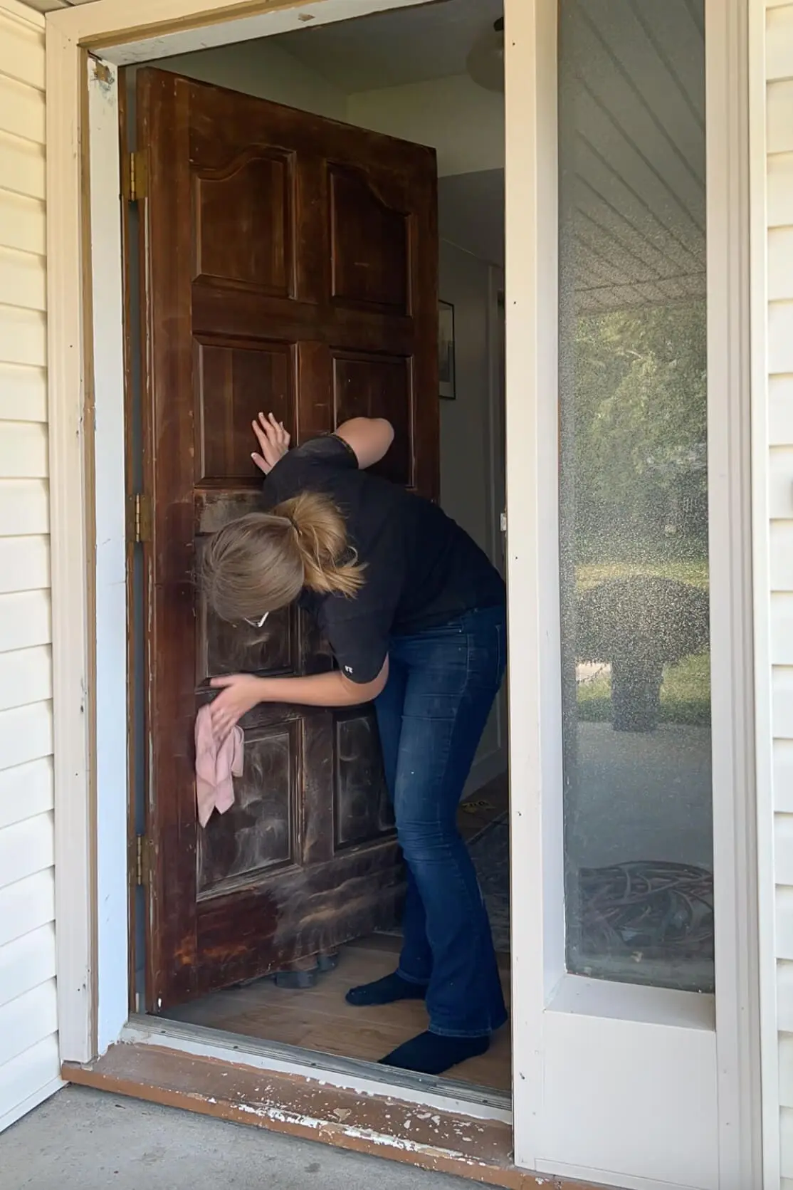 Wiping off a door after sanding to get it ready to paint.